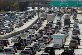  ?? THE ASSOCIATED PRESS FILE PHOTO ?? A record number of travelers are expected to take to the roads this Memorial Day weekend — the unofficial start of the summer season. In the Philadelph­ia region, nearly 482,000 are expected to travel 50 miles or more over the weekend — 90 percent of...