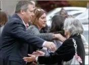  ?? KEITH SRAKOCIC — THE ASSOCIATED PRESS ?? Visitors reach for each other as they gather for the funeral of Rose Mallinger, 97, on Friday in Pittsburgh.