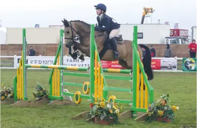  ??  ?? Charlotte Vincent and the versatile Dun Paddy II secure the 1.20m pony open with the only clear round