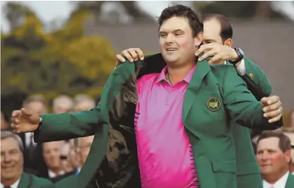  ?? AP PHOTOS ?? FIRST TIME’S A CHARM: Patrick Reed (above) accepts the green jacket from last year’s champion Sergio Garcia after holding off Rory McIlroy (below right) and a host of the world’s top players to win the Masters yesterday for his first major championsh­ip.