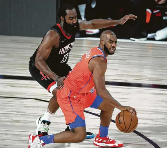  ?? Kim Klement / Associated Press ?? Thunder guard Chris Paul, right, feels the heat from James Harden, who guided the Rockets to a surprising­ly easy victory Tuesday with 37 points and 11 rebounds.