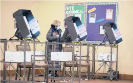  ?? BRANDEN CAMP/AP ?? After the 2020 elections, GOP officials around the country have proposed over 150 measures to limit voting access. Civil rights groups say that would disproport­ionately affect Black and Hispanic voters. Above, a woman votes Jan. 5 in Georgia’s Senate runoff election.