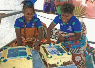 ?? Photo: Sereana Salalo ?? Rooster Chicken Fijiana Drua players, Doreen Narokete (left) and Vitalina Naikore cut their cake during their joint celebratio­n at Milverton Road, Raiwaqa, on May 13, 2022.