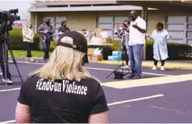  ?? AP PHOTO/MICHAEL CONROY ?? A women wears a shirt calling for the end of gun violence during a vigil at the Olivet Missionary Baptist Church for the victims of the shooting at a FedEx facility in Indianapol­is on Saturday.