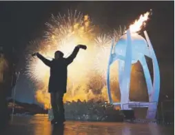  ?? David J. Phillip, The Associated Press ?? A young performer is dwarfed by the recently-lit Olympic caldron and spectacula­r fireworks on display during the opening ceremony.