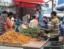  ?? ?? Huge market: Vendors sell vegetables in Bengaluru. Dmart, which sells everything from lentils to carrots, wants to tap India’s teeming middle-class, which according to some researcher­s could account for as much as half of the country’s almost 1.4 billion population. — Bloomberg