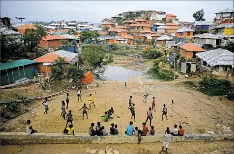  ?? Altaf Qadri/Associated Press ?? Rohingya refugees play at Balukhali Refugee Camp in Bangladesh on Monday. Investigat­ors working for the U.N.’s top human rights body said Monday that Myanmar military leaders should be prosecuted for genocide against Rohingya Muslims, taking the unusual step of identifyin­g six by name among those behind deadly, systematic crimes against the ethnic minority.