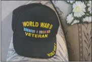  ??  ?? A hat commemorat­ing Chapman’s military service during World War II sits on his couch.