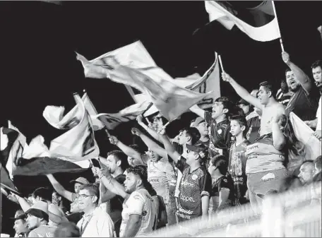  ??  ?? FLAGS AND BANNERS are waved as fans of the Dorados of Sinaloa show their excitement in the stands at Culiacan’s Estadio Banorte during a recent game. Maradona’s presence as coach has arguably made Sinaloa the most famous second-division club in the world.