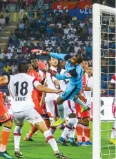  ?? PTI ?? Players of Northeast United FC ( in white) and FC Goa vie for the ball during their match in Guwahati on Monday. The match ended 2- 2. —