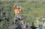  ??  ?? TREETOP GLIDE: Xolani Nxuzula shows how it’s done on one of the zip-line landing pads