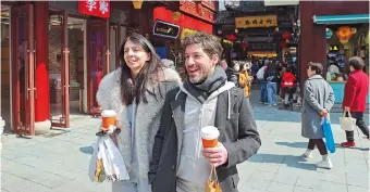  ?? ?? Above: Foreign tourists visit the Yuyuan Garden scenic area yesterday.