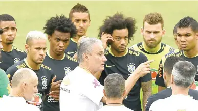  ?? AFP PHOTO ?? Adenor Leonardo Bacchi also known as Tite (center) gives instructio­ns to his players during Brazil’s preparatio­n for the 2018 World Cup held in Russia.