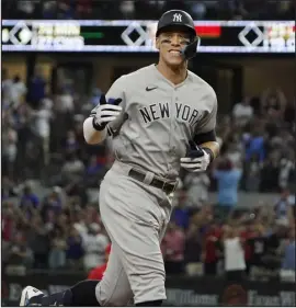  ?? LM OTERO — ASSOCIATED PRESS FILE PHOTO ?? The Yankees’ Aaron Judge celebrates after hitting a solo home run, his 62nd of the season, against the Texas Rangers in Arlington, Texas, on Oct. 4. With the home run, Judge set the AL record for home runs in a season, passing Roger Maris.