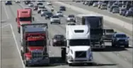  ??  ?? Truckers are warning that a government plan to electronic­ally limit the speed of tractor-trailer rigs will lead to highway traffic jams and even an increase in deadly runins with cars allowed to travel at faster speeds.