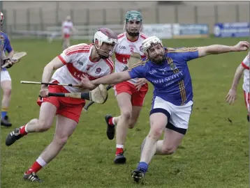  ??  ?? Derry’s Darragh McCloskey holds on tight to Wicklow’s Andy O’Brien in Bray. Photos: Barbara Flynn