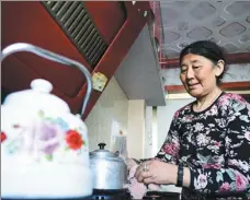  ?? ZHANG HONGXIANG / XINHUA ZHANG LONG / XINHUA ?? Students receive training at a vocational school in Delingha, Qinghai province, last year. A number of education and training programs are being used to alleviate poverty nationwide. affordable housing complex in Delingha; a woman cleans a kettle in her kitchen at an affordable community in the city in 2014.