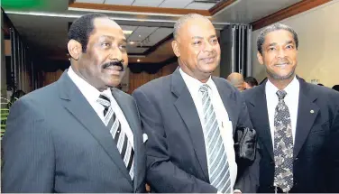  ?? FILE ?? Michael Ricketts (centre) and A.B. Stewart Stephenson (right), prospectiv­e successors to Horace Burrell as JFF president, pose with the late head honcho in this 2009 photograph.