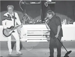  ?? TREVOR HUGHES/USA TODAY ?? Foreigner co-founders Mick Jones, left, and Lou Gramm reunited on stage in Sturgis, S.D., in August.