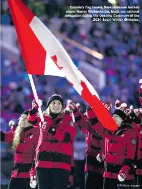  ?? AFP/Getty Images ?? Canada’s flag bearer, Saskatchew­an hockey player Hayley Wickenheis­er, leads our national delegation during the Opening Ceremony of the
2014 Sochi Winter Olympics.