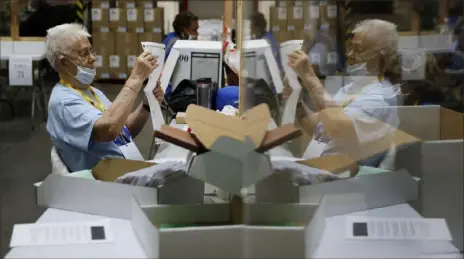  ?? John Locher/Associated Press ?? Election workers process mail-in ballots during a nearly all-mail primary election in Las Vegas on June 9.