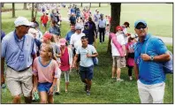  ?? NWA Democrat-Gazette/CHARLIE KAIJO ?? Fans follow Nasa Hataoka and her group as they make their way through the seventh fairway during the final round of the LPGA Northwest Arkansas Championsh­ip on Sunday at Pinnacle Country Club in Rogers. The tournament, which was started in 2007, is...