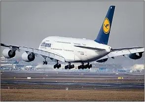  ?? AP/MICHAEL PROBST ?? A Lufthansa airline Airbus A380 jumbo jet lands Thursday in Frankfurt, Germany. European plane manufactur­er Airbus said Thursday that it will stop making the world’s biggest passenger jet.