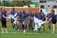  ?? BARRY TAGLIEBER - FOR DIGITAL FIRST MEDIA ?? The Phuture Phantoms football had their home opener against the Pottstown PAL Football with four games at Washington Field on Sept. 17. The 4th grade team breaks through the banner before their game.