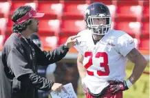  ?? COLLEEN DE NEVE/ CALGARY HERALD ?? Stampeders special teams co- ordinator Mark Kilam chats with William Langlais during practice on Wednesday as Calgary prepares to face the Riders in Regina on Saturday.