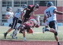  ??  ?? McMaster’s Blake Reason dives over the goal line to score against the University of Toronto Blues.