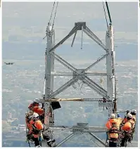  ??  ?? One of the transmissi­on towers serving Mercury’s Turitea wind farm takes shape on the ridges above Palmerston North.