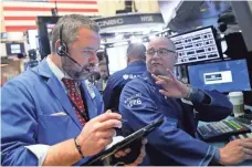  ?? ANDREW GOMBERT, EPA ?? Traders on the floor of the New York Stock Exchange have had a rough start to the new year.