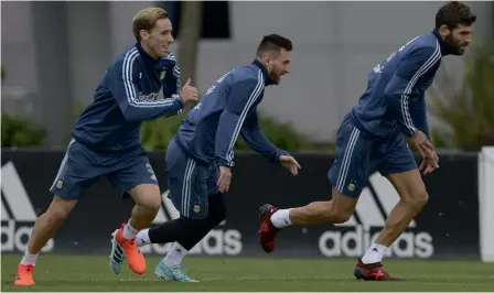  ?? — AFP ?? Argentina’s Lionel Messi (centre) at a training session in Buenos Aires, on Tuesday. They are presently fifth on the points table.