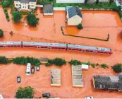  ?? AFP ?? ■ A regional train stands in the train station in the flooded town of Kordel on Thursday.