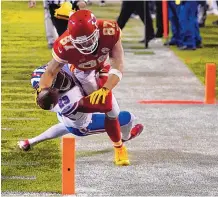  ?? JEFF ROBERSON/ ASSOCIATED PRESS ?? Kansas City Chiefs tight end Travis Kelce (87) dives toward the goal line over Buffalo Bills cornerback Josh Norman (29) during Sunday’s AFC championsh­ip game.