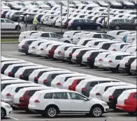  ?? (AP/Hendrik Schmidt) ?? New Volkswagen vehicles sit in a lot Tuesday at the Volkswagen plant in Zwickau, Germany. German automaker Volkswagen said it is shutting down most of its European plants for two weeks because of the coronaviru­s outbreak.