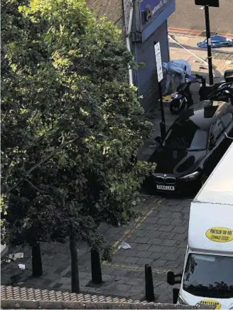  ??  ?? CRIME SCENE: Police forensics officers examined the van believed to be involved in an incident near Finsbury Park Mosque in which a vehicle ploughed into pedestrian­s, injuring several