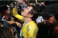  ?? Associated Press ?? ■ Britain's Geraint Thomas, wearing the overall leader's yellow jersey, pours water over his face after the 20th stage of the Tour de France cycling race Saturday in Espelette, France.