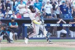  ?? AP PHOTO BY WILFREDO LEE ?? Atlanta Braves designated hitter Marcell Ozuna connects for a go-ahead threerun homer with two outs in the top of the ninth inning during Sunday’s game against the Miami Marlins. The Braves won 9-7.
