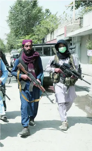  ?? AP ?? Talibanes patrullan las calles de Kabul con armas americanas confiscada­s