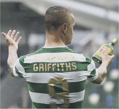  ??  ?? Leigh Griffiths was booked after showing the referee a bottle which was thrown at him. Left: The striker ties a scarf around the post at full-time.