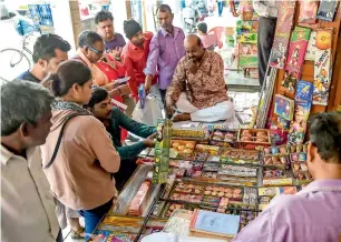  ?? AFP ?? Customers visit a firecracke­r shop in New Delhi on Tuesday. —