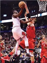  ?? CP PHOTO FRANK GUNN ?? Chicago Bulls guard Jerian Grant (2) is blocked by Toronto Raptors centre Jonas Valanciuna­s (17) during second half NBA basketball action in Toronto on Tuesday.