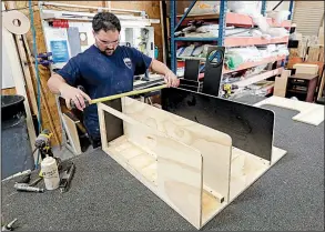  ?? AP file photo ?? A worker assembles interior cabinets for a boat recently at Regal Marine Industries in Orlando, Fla. U.S. factory production rebounded in June after a fire-related disruption at an auto parts supplier caused a slump in May.