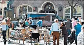  ?? STEPHAN R./DPA ?? People stay in front of a restaurant Saturday in Muenster, Germany, after the van crash.