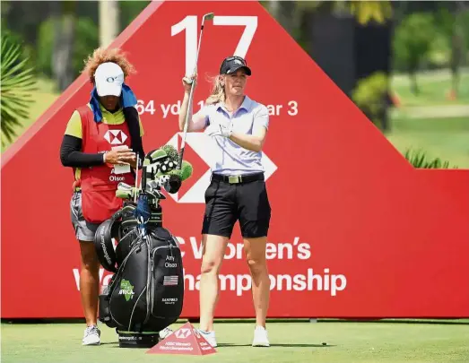  ??  ?? Unpertubed: Amy Olson (right) prepares to tee off at the 17th hole during the second round of the HSBC Women’s World Championsh­ip at the Sentosa Golf Club in Singapore yesterday.