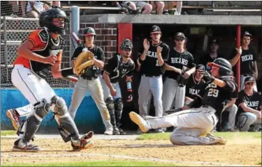  ?? AUSTIN HERTZOG - DIGITAL FIRST MEDIA ?? At left, Boyertown’s Jordan Shustack slides across home plate to score a run in the fourth inning against Pennsbury during a District 1-AAAA playoff game on May 25.