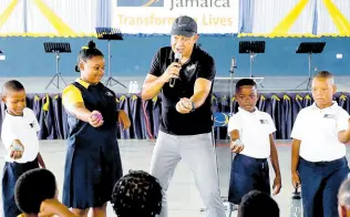  ?? CONTRIBUTE­D ?? Minister of Health & Wellness Dr Christophe­r Tufton demonstrat­es the use of a stress ball with students of Christel House in Spanish Town, St Catherine, last Wednesday during a wellness check-In done at the institutio­n as part of the ongoing Do Your Share mentalwell­ness campaign.