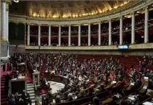  ?? Lewis Joly/Associated Press ?? French lawmakers gather Monday at the National Assembly in Paris, adopting a divisive pension bill raising the retirement age in France from 62 to 64,