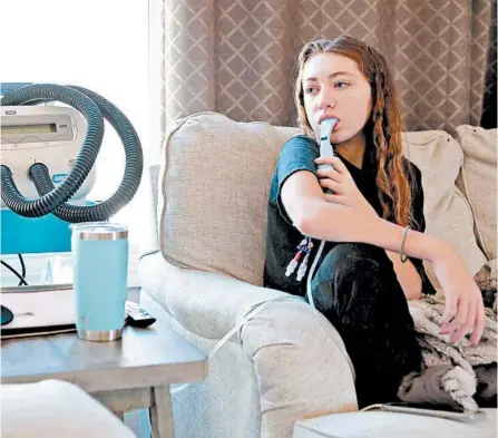  ?? CRISTINA M. FLETES/ST. LOUIS POST-DISPATCH ?? Hannah Krumrey, 20, is waiting on her insurance to approve her applicatio­n for the new cystic fibrosis drug, Trikafta.